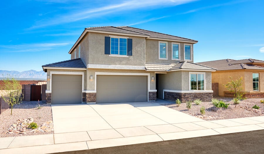 3145 Wolf Tail Loop NE, Rio Rancho, NM 87144 - view of front of home featuring stone siding, concrete driveway, an attached garage, stucco siding, and a mountain view