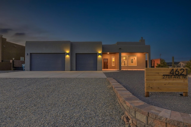 4621 27th Ave NE, Rio Rancho, NM 87144 - view of front of home with concrete driveway, stucco siding, and a garage