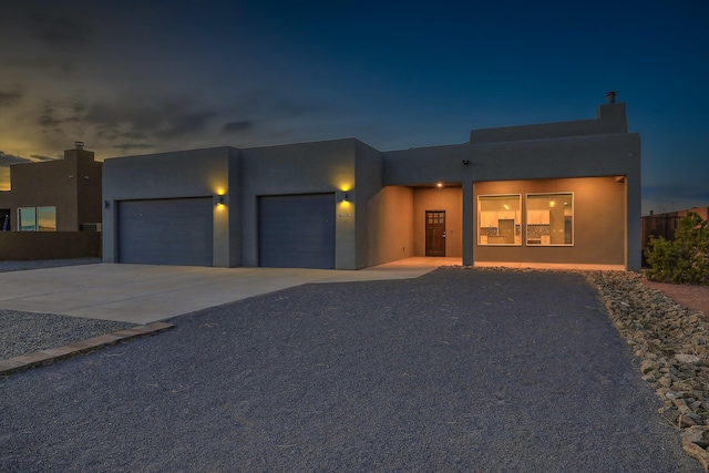 4621 27th Ave NE, Rio Rancho, NM 87144 - view of front of property featuring an attached garage, stucco siding, and concrete driveway