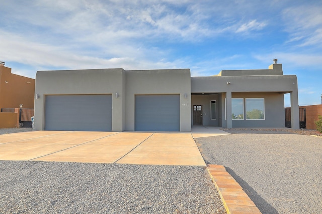 4621 27th Ave NE, Rio Rancho, NM 87144 - adobe home with driveway, a garage, and stucco siding