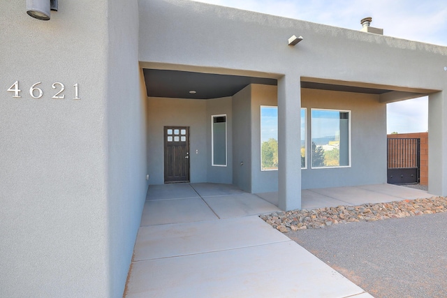 4621 27th Ave NE, Rio Rancho, NM 87144 - doorway to property featuring stucco siding and a patio area