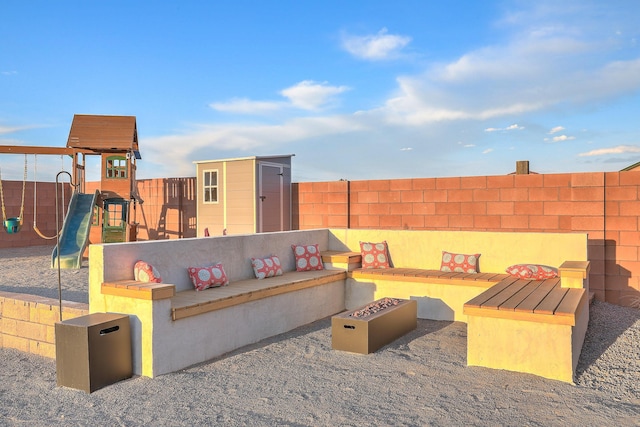 4621 27th Ave NE, Rio Rancho, NM 87144 - view of patio featuring a playground and a fire pit