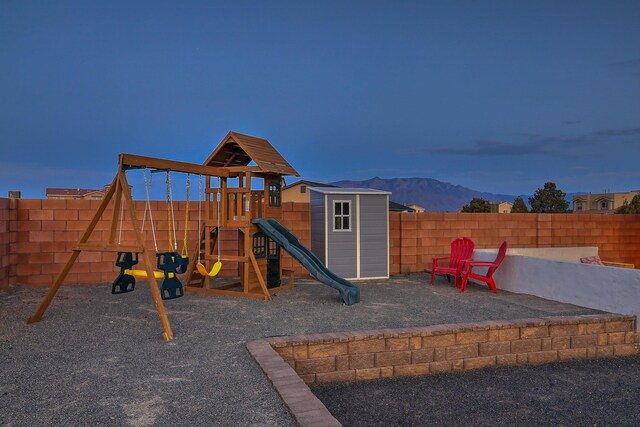 4621 27th Ave NE, Rio Rancho, NM 87144 - view of play area with a fenced backyard and a mountain view