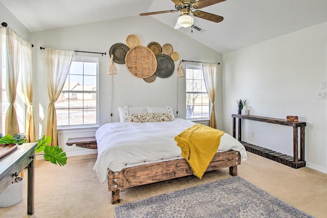 carpeted bedroom with vaulted ceiling, baseboards, a ceiling fan, and multiple windows