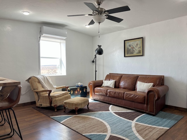 living area with baseboards, wood finished floors, a wall unit AC, and ceiling fan
