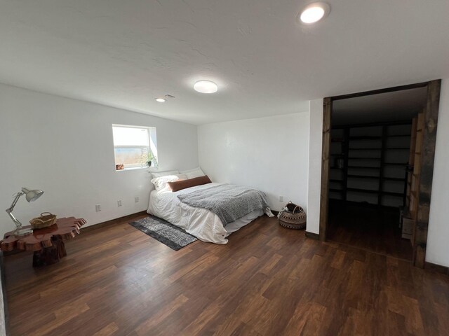 bedroom with wood finished floors and baseboards