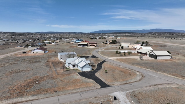 birds eye view of property featuring a mountain view