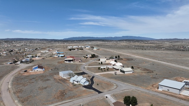 birds eye view of property featuring a desert view and a mountain view