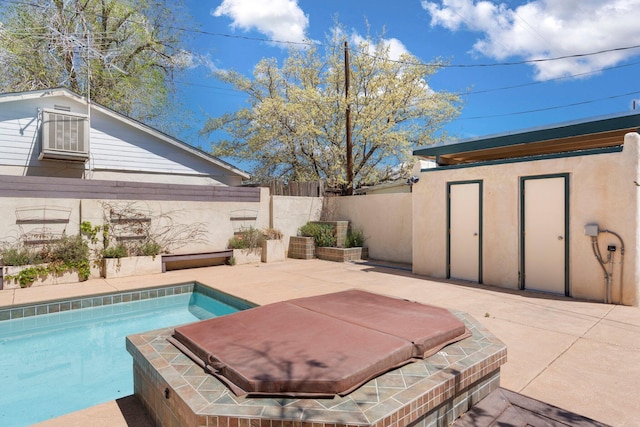 view of swimming pool with fence and a patio area