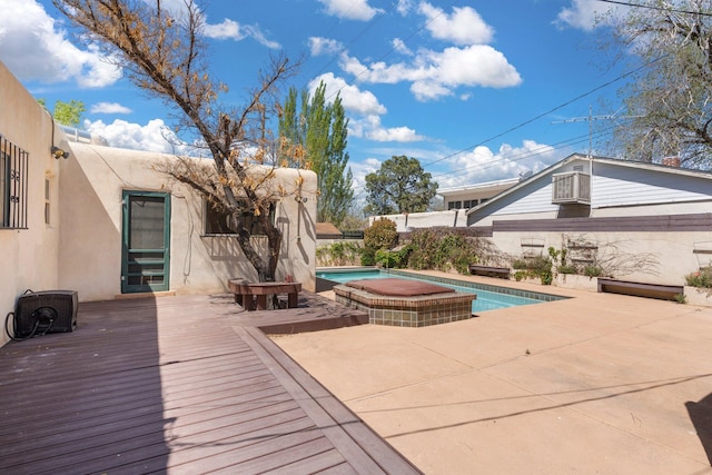 view of swimming pool featuring a patio area, a fenced in pool, a hot tub, and a deck