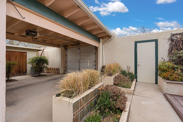 exterior space featuring stucco siding and fence