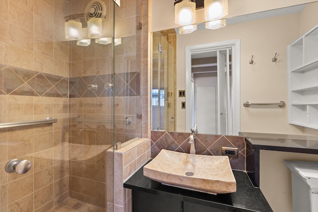 full bathroom featuring a shower stall, tasteful backsplash, and vanity
