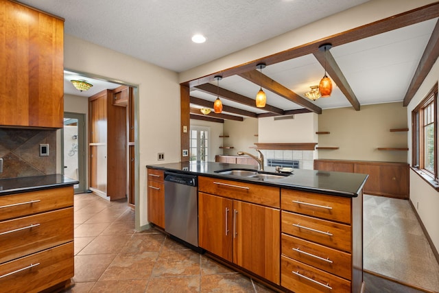 kitchen with brown cabinets, stainless steel dishwasher, dark countertops, and a sink