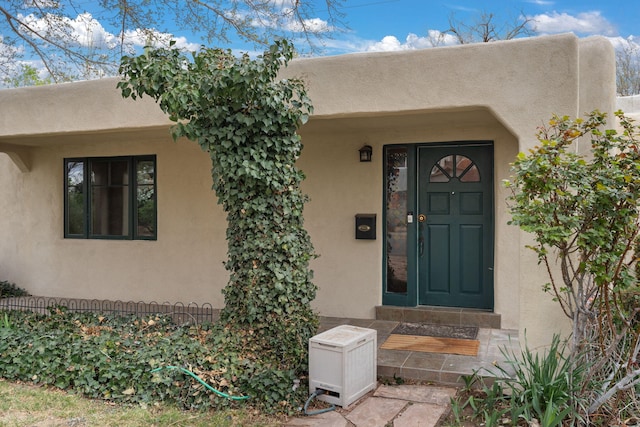 entrance to property with stucco siding