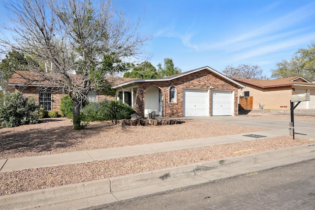ranch-style house featuring a garage, brick siding, and driveway