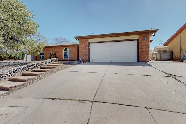 8021 Ruidoso Ct NE, Albuquerque, NM 87109 - ranch-style home featuring brick siding, driveway, and a garage