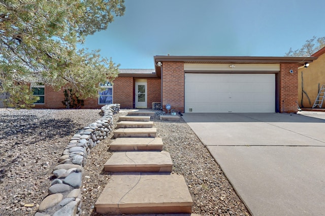 8021 Ruidoso Ct NE, Albuquerque, NM 87109 - ranch-style house featuring driveway, brick siding, and a garage