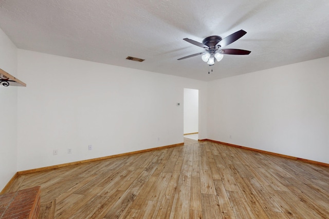 8021 Ruidoso Ct NE, Albuquerque, NM 87109 - unfurnished room featuring baseboards, a ceiling fan, light wood-style floors, and visible vents