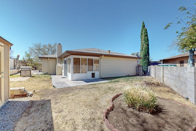 8021 Ruidoso Ct NE, Albuquerque, NM 87109 - back of property featuring a patio area, a lawn, a chimney, and a fenced backyard