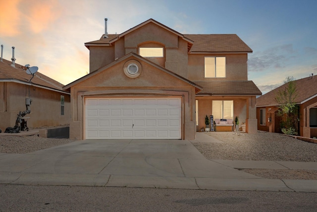 5909 Night Shadow Ave NW, Albuquerque, NM 87114 - view of front of home with stucco siding, driveway, an attached garage, covered porch, and a shingled roof