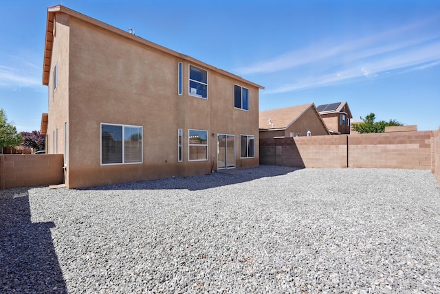 5909 Night Shadow Ave NW, Albuquerque, NM 87114 - rear view of house featuring a fenced backyard, stucco siding, and a patio area