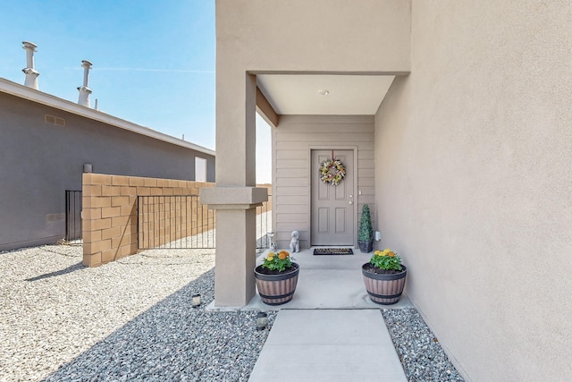 6300 Gannett Dr NE, Rio Rancho, NM 87144 - doorway to property featuring stucco siding