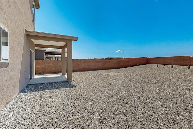 6300 Gannett Dr NE, Rio Rancho, NM 87144 - fenced backyard with a patio area