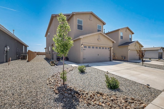 6300 Gannett Dr NE, Rio Rancho, NM 87144 - traditional home with stucco siding, concrete driveway, a garage, and a gate