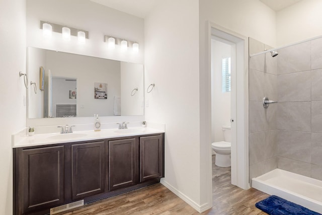 6300 Gannett Dr NE, Rio Rancho, NM 87144 - full bathroom featuring wood finished floors, double vanity, and a tile shower