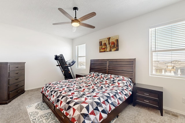 6300 Gannett Dr NE, Rio Rancho, NM 87144 - bedroom with light carpet, a textured ceiling, and ceiling fan