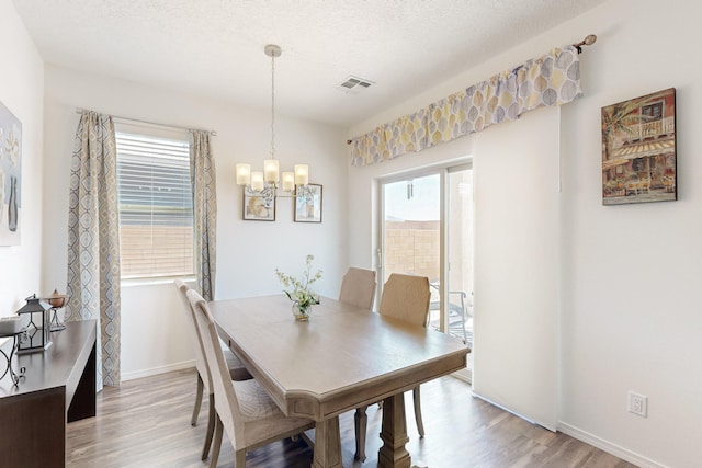 6300 Gannett Dr NE, Rio Rancho, NM 87144 - dining space with light wood-style flooring and a chandelier