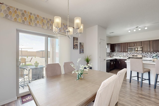 6300 Gannett Dr NE, Rio Rancho, NM 87144 - dining space featuring a chandelier and light wood-style floors
