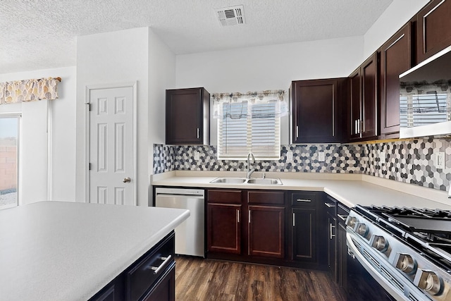 6300 Gannett Dr NE, Rio Rancho, NM 87144 - kitchen with appliances with stainless steel finishes, a textured ceiling, light countertops, dark wood-type flooring, and dark brown cabinetry
