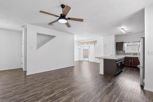 6300 Gannett Dr NE, Rio Rancho, NM 87144 - kitchen featuring open floor plan, dark wood finished floors, a textured ceiling, light countertops, and a ceiling fan
