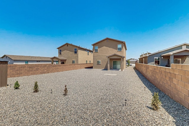 6300 Gannett Dr NE, Rio Rancho, NM 87144 - rear view of house featuring a fenced backyard, stucco siding, and a residential view