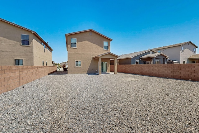 6300 Gannett Dr NE, Rio Rancho, NM 87144 - back of property featuring a fenced backyard, stucco siding, and a patio area