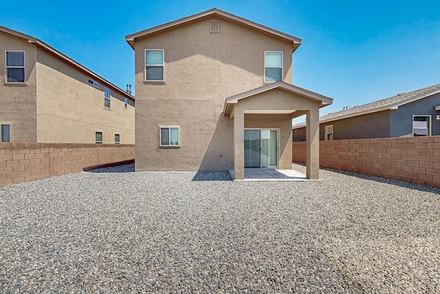 6300 Gannett Dr NE, Rio Rancho, NM 87144 - back of house featuring stucco siding, a fenced backyard, and a patio