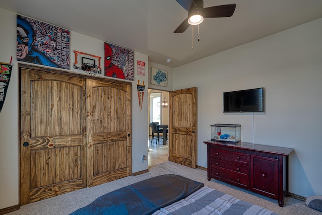 bedroom with baseboards, a ceiling fan, and carpet