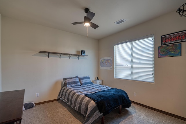 carpeted bedroom with visible vents, baseboards, and ceiling fan