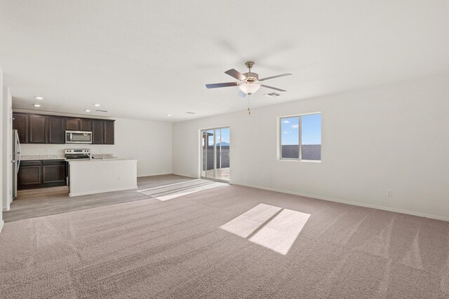 2606 Desi Loop, Belen, NM 87002 - unfurnished living room featuring ceiling fan, light carpet, recessed lighting, and baseboards