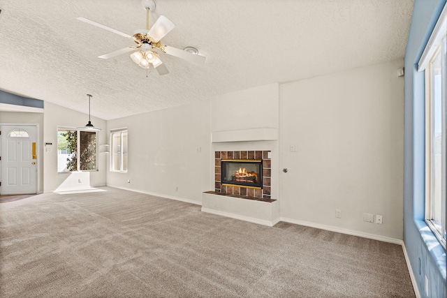 275 Chaparral Loop SE, Rio Rancho, NM 87124 - unfurnished living room featuring a ceiling fan, a textured ceiling, carpet, a fireplace, and lofted ceiling