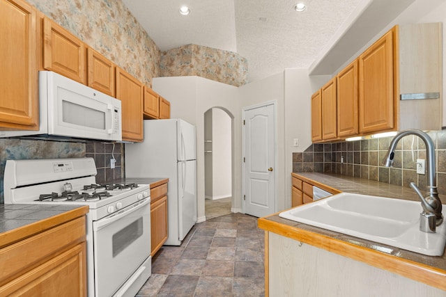 275 Chaparral Loop SE, Rio Rancho, NM 87124 - kitchen featuring tile countertops, a sink, white appliances, baseboards, and tasteful backsplash