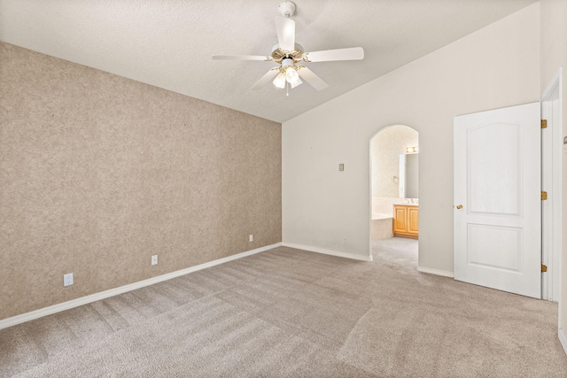 275 Chaparral Loop SE, Rio Rancho, NM 87124 - empty room featuring ceiling fan, arched walkways, baseboards, light colored carpet, and lofted ceiling