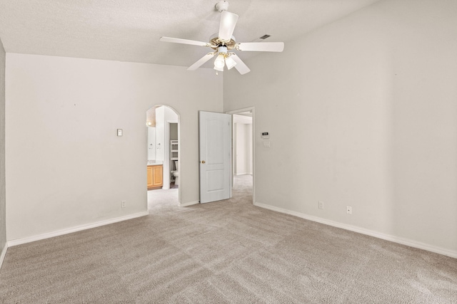 275 Chaparral Loop SE, Rio Rancho, NM 87124 - unfurnished bedroom featuring light colored carpet, arched walkways, baseboards, high vaulted ceiling, and ceiling fan