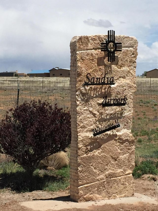 community / neighborhood sign with fence