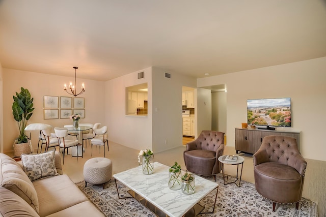 living room with visible vents and a chandelier