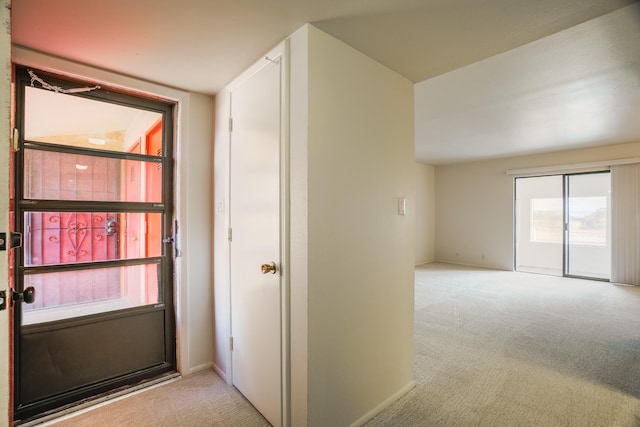 interior space with baseboards and carpet