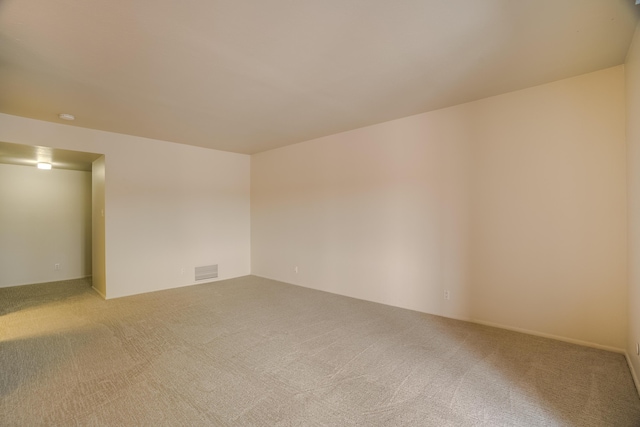 carpeted spare room featuring visible vents