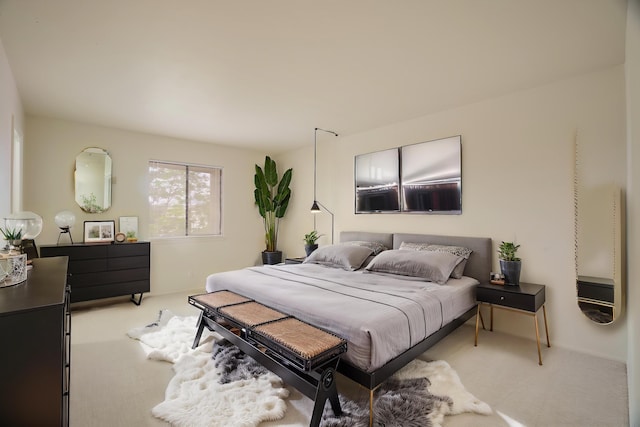 bedroom featuring light carpet