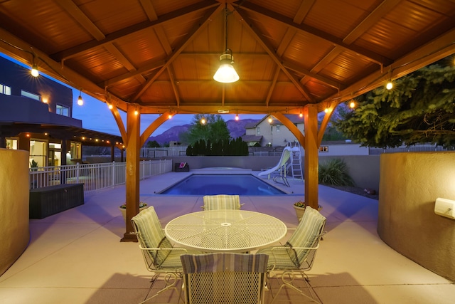 view of patio / terrace featuring a gazebo, a fenced in pool, and a fenced backyard